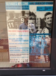 Ad for the refugee match in the window of a local business. 